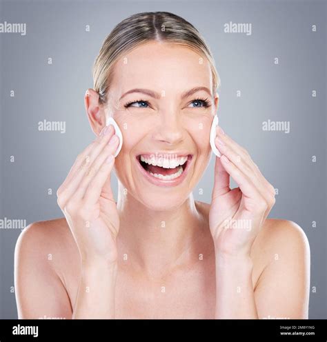 Toner aids the skin in retaining moisture. Studio shot of an attractive mature woman using ...