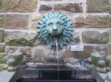 lion head concrete wall fountain free image | Peakpx
