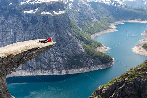 Ad: Trolltunga rock by An_cika on @creativemarket. Travelers lying on ...