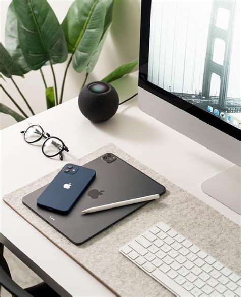 Apple Computer and Accessories on White Desk