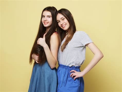 Lifestyle and People Concept: Two Girl Friends Standing Together Stock Photo - Image of fashion ...
