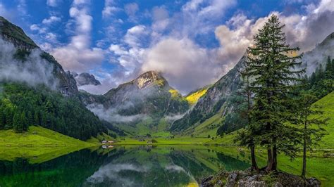 Beautiful Landscape View Of Mountains Surrounded By Fog Under Cloudy ...