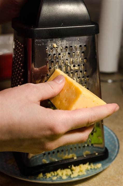 A cook grating cheese stock image. Image of orange, grate - 143500017