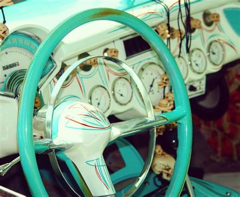 the steering wheel and dashboard of an old car