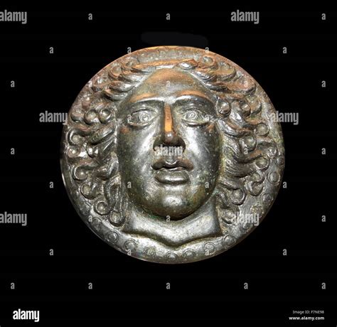 Greek bronze disc, with a head of the sun-god Apollo Helios. 5th-3rd century BC Stock Photo - Alamy