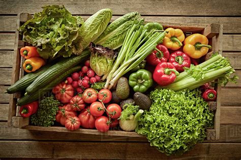 Still life fresh, organic, healthy vegetable harvest variety in wood crate - Stock Photo - Dissolve