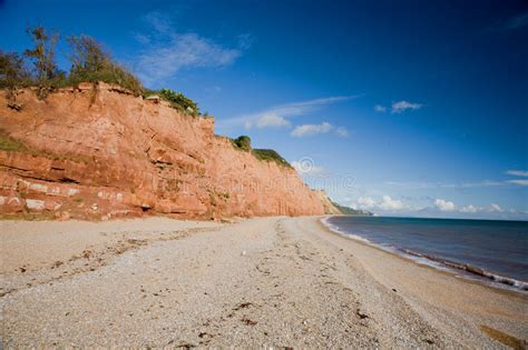 Pebble Beach and Sandstone Cliffs Stock Photo - Image of waves, sandstone: 1311914