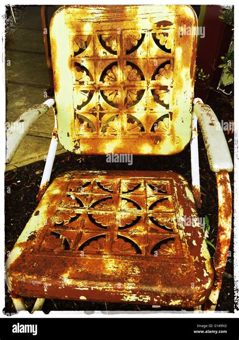 Old rusted metal outdoor chair Stock Photo - Alamy