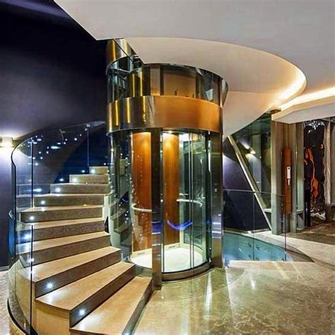 Mansion Homes™ and Dream Houses Luxury Real Estate — Spiral staircase with a glass elevator in ...