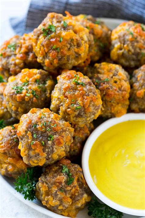 A platter of sausage cheese balls with honey mustard sauce for dipping. | Party appetizers easy ...