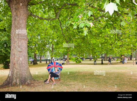 Woman with a british umbrella hi-res stock photography and images - Alamy