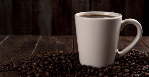 Coffee Mug Surrounded With Coffee Beans · Free Stock Photo