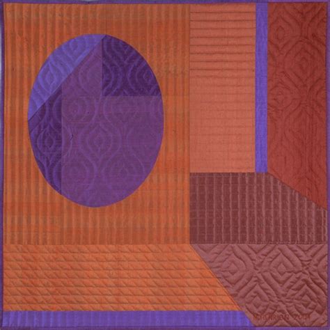 an orange and purple quilt with a blue circle in the center on top of it