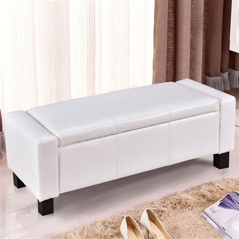a white bench sitting on top of a carpet covered floor next to a pair ...
