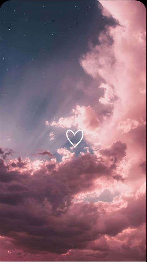 Download a pink sky with clouds and a heart | Wallpapers.com