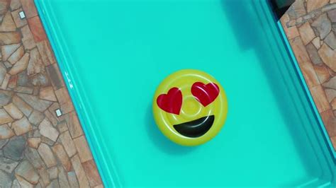 Smile emoji icon floating at swimming pool at countryside, Stock Footage