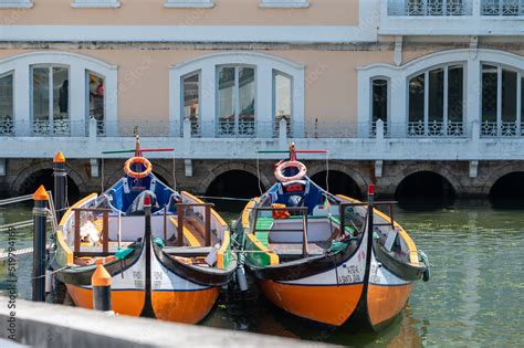 Traditional boats in the canal of Aveiro, Portugal. The colorful Moliceiro de Aveiro boat tours ...