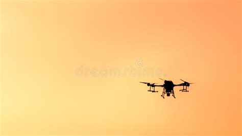 Silhouette Drone Flying on Sunset. Stock Photo - Image of drone, city: 243714102