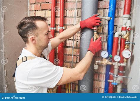 Plumber Installing and Mounting Water Equipment - Meter, Filter and Pressure Reducer Stock Photo ...