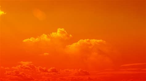 Premium Photo | Orange sky Clouds moving away rolling colorful sunset light dramatic clouds in ...