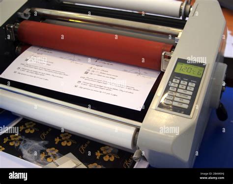 Plastic laminating machine Stock Photo - Alamy