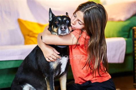 Little girl hugs her dog having fun at home — person, female - Stock ...