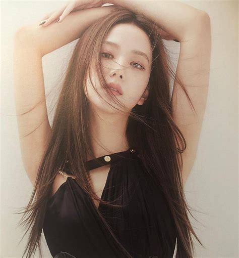 a woman with long brown hair posing for a photo wearing a black dress and choker