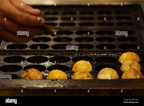 The cooking of Takoyaki. The popular Japanese street food Stock Photo - Alamy