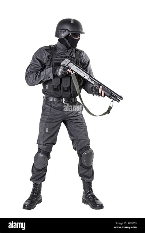 Spec ops police officer SWAT in black uniform with shotgun, studio shot ...