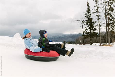 "Family Together Snow Tubing Winter Family Travel Lifestyle" by Stocksy Contributor "Raymond ...