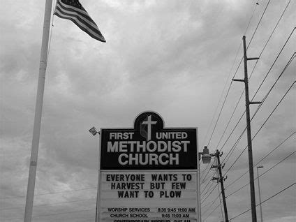 a church sign in front of an american flag and power lines with the ...