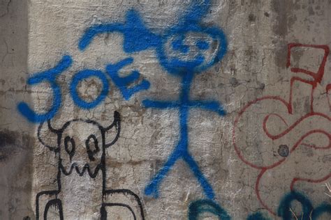 Spray Paint Graffiti Figure In Blue On Wall - Texture X