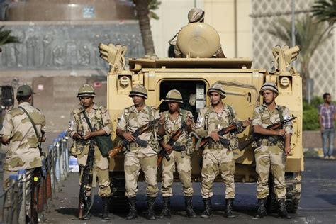 Egyptian Army soldiers take their positions near an M113 APC to guard ...