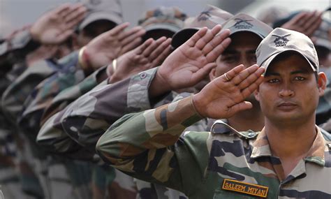 Soldiers from the Indian Army salute during a wreath laying ceremony ...