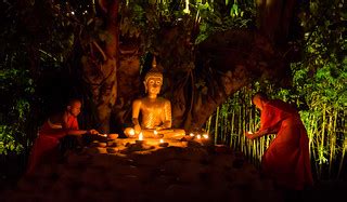 Monks lighting candles at Wat Phan Tao on Makha Bucha Day … | Flickr