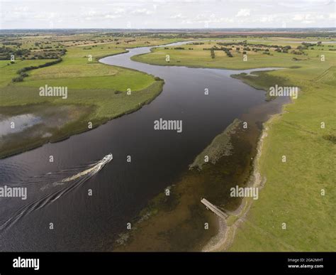 Aerial view of a boat exploring River Shannon along the banks of the Clonmacnoise ruins; County ...