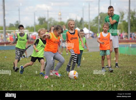 KIds youth football team training with his coach Stock Photo - Alamy