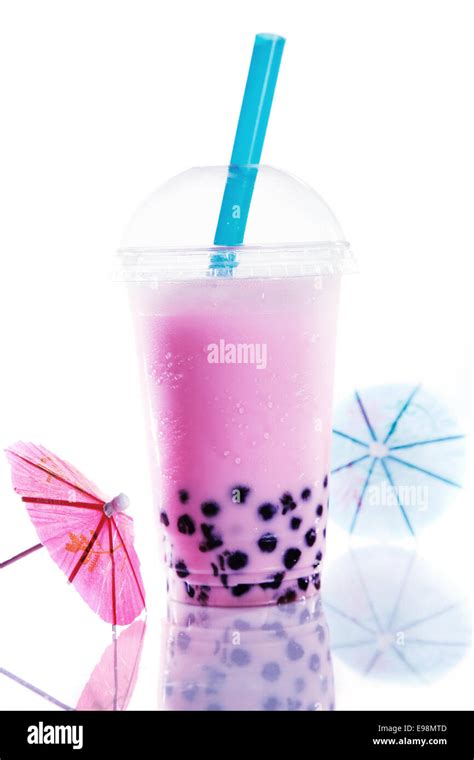 Healthy pink berry bubble tea with a good head of froth or bubbles from shaking and colourful ...