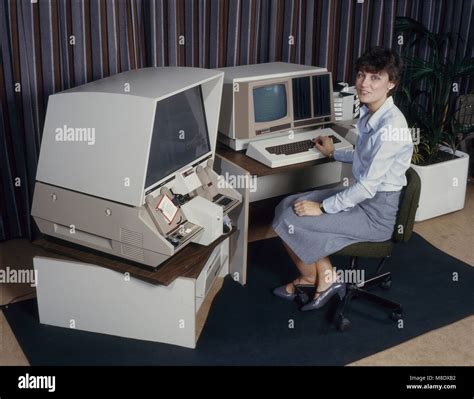 Woman using a 3M computerised microfilm reader - 1980's Stock Photo - Alamy