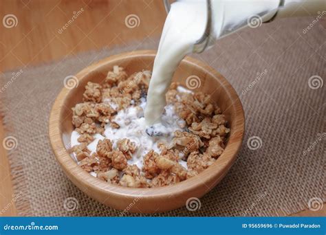 Pouring Milk into Cereal Breakfast in Wooden Bowl Stock Photo - Image of wooden, bowl: 95659696