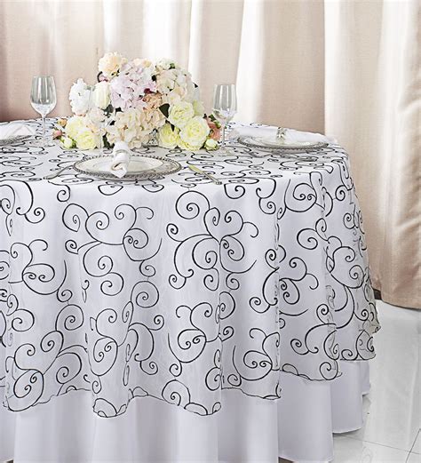 Enhance your aesthetic with our 90" round Embroidered Organza Table Overlays. These elegant ...