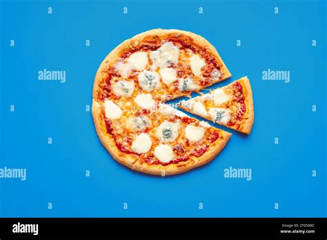 Homemade pizza quattro formaggi isolated on a blue background. Delicious pizza with four types ...