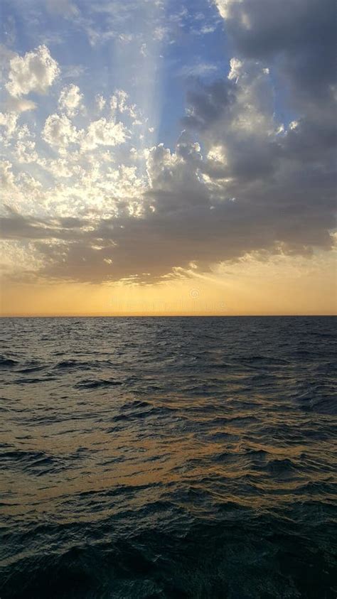 Dark Blue Ocean with Beautiful Clouds and Sun Rays Stock Photo - Image ...