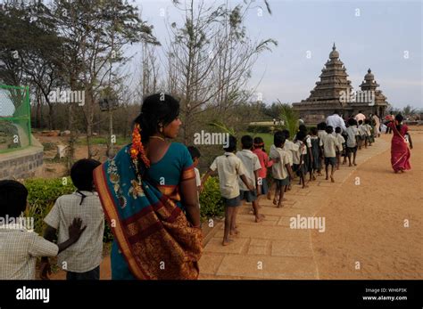 Teachers accompany barefoot school children walk in a line to see 8th ...