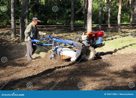 Tractor with Plough in the Field Editorial Photo - Image of field ...