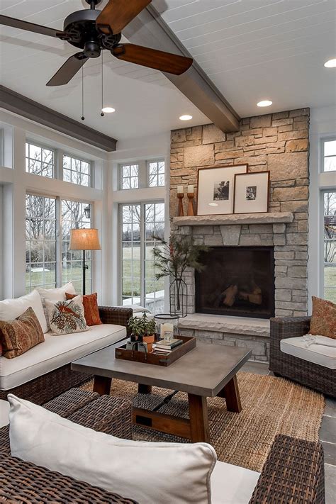 a living room filled with furniture and a fire place in the middle of a room