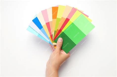 Premium Photo | Female hand holding color palettes on white background