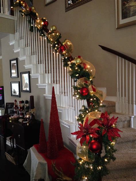 christmas decorations on the banisters and stairs are decorated with red, gold and green ornaments