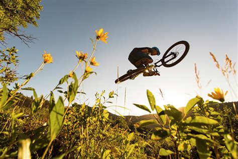 Mountain Biker Doing Stunt In Mid-air Photograph by Wray Sinclair | Fine Art America