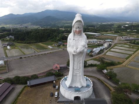 Giant Buddhist goddess in Japan gets face mask to pray for end of COVID-19 | Reuters